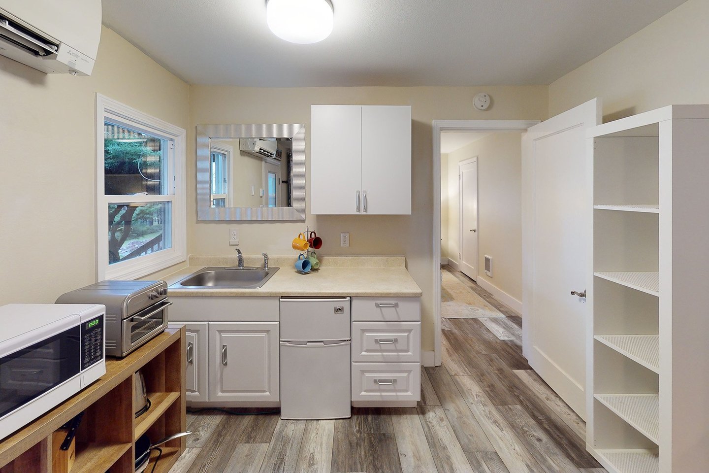 Cute kitchenette perfect for your stay with hallway to the bedroom.
