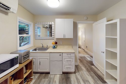 Cute kitchenette perfect for your stay with hallway to the bedroom.