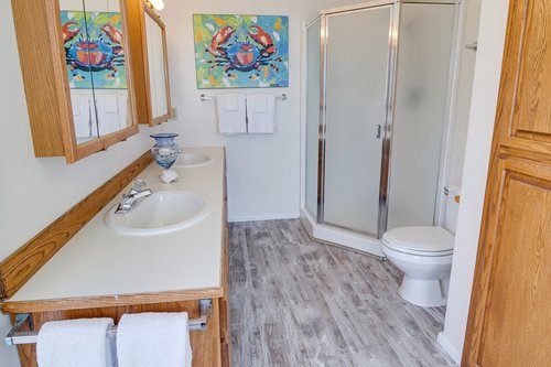 The ensuite bath also has a standalone shower in addition to the jetted tub.