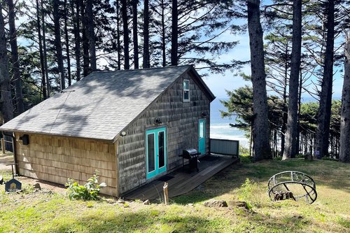 Cozy cabin perched above the Pacific Ocean.