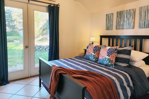 Main floor bedroom with queen bed has exterior access.