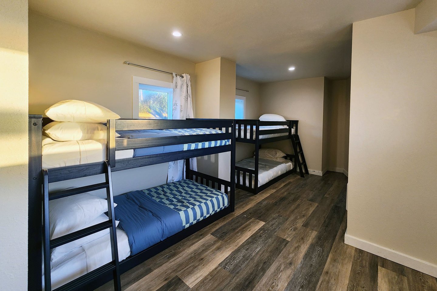 Bunk beds are tucked away behind the media/game room but open to the room.