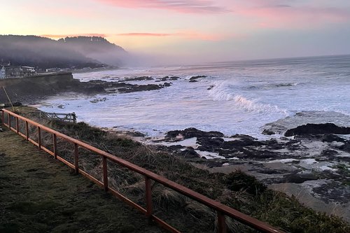 Fenced yard looks out over the famous Yachats basalt shoreline.
