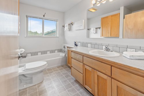 One of two bathrooms in the home is next to the primary bedroom.