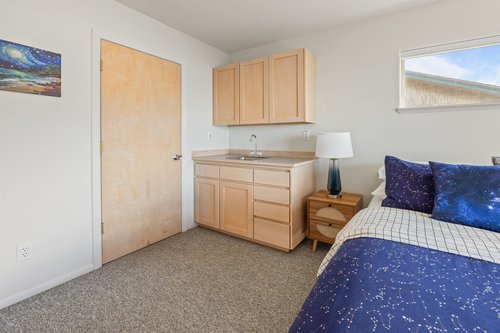 This bedroom has its own sink and space for your extras.