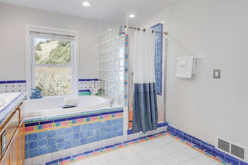 This large bath is part of the primary suite. It has both a tub and a walk in shower.