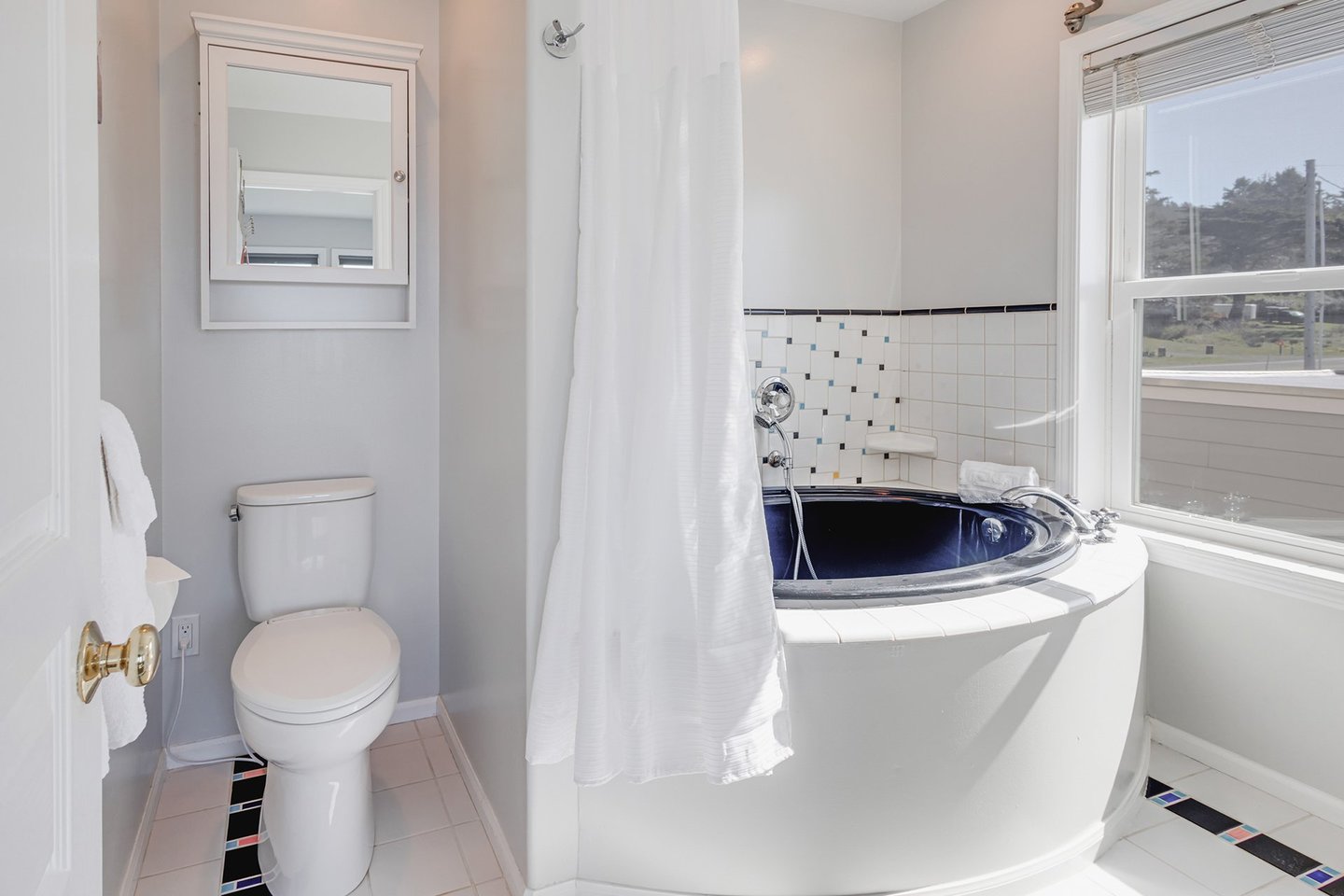 The ensuite bath has a tub and shower wand.