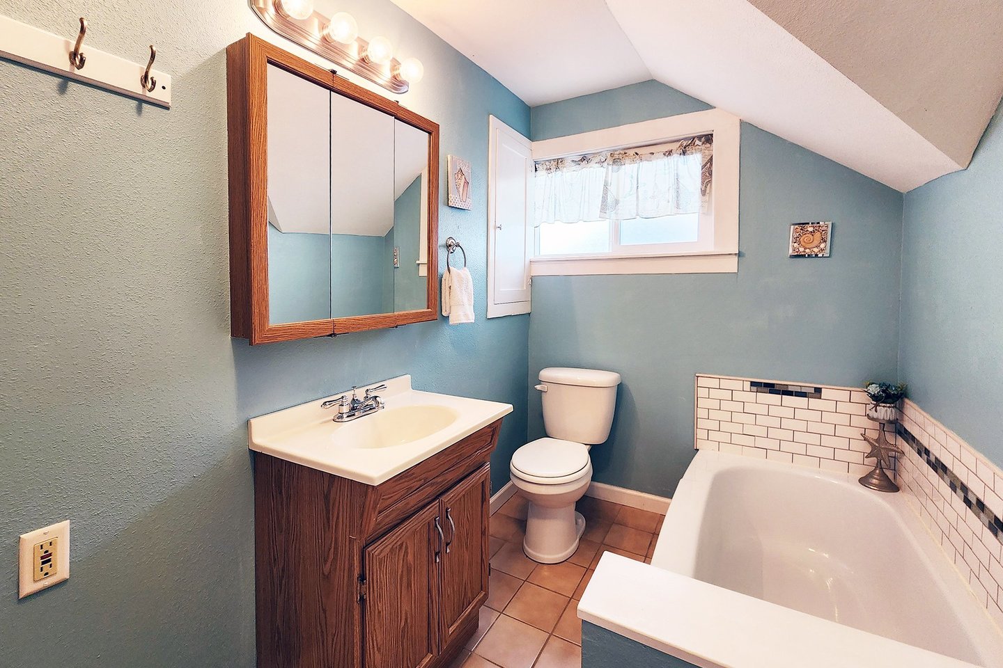 Upstairs bath has a bathtub.