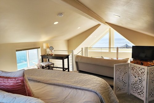 Spacious loft with sitting area and desk along with ocean view bed!