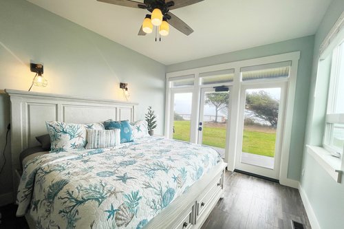 Ground floor bedroom, ensuite bath and King bed with access to the patio.