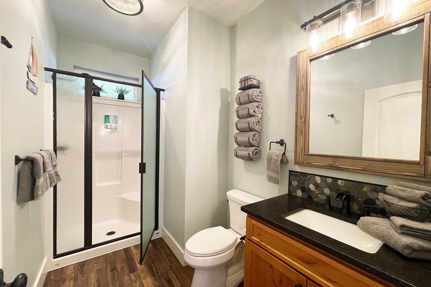 A bath in the hallway on the entry level with walk in shower.