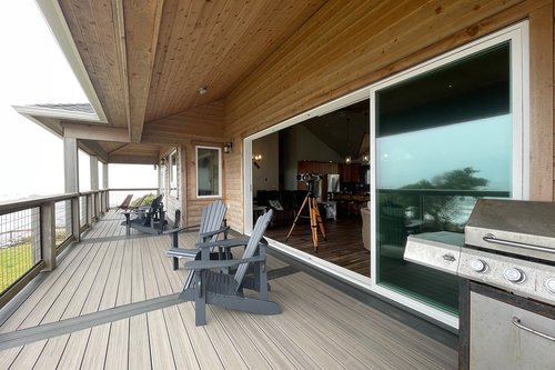 The sliding doors open all the way to bring the outdoor in and expand the living space.