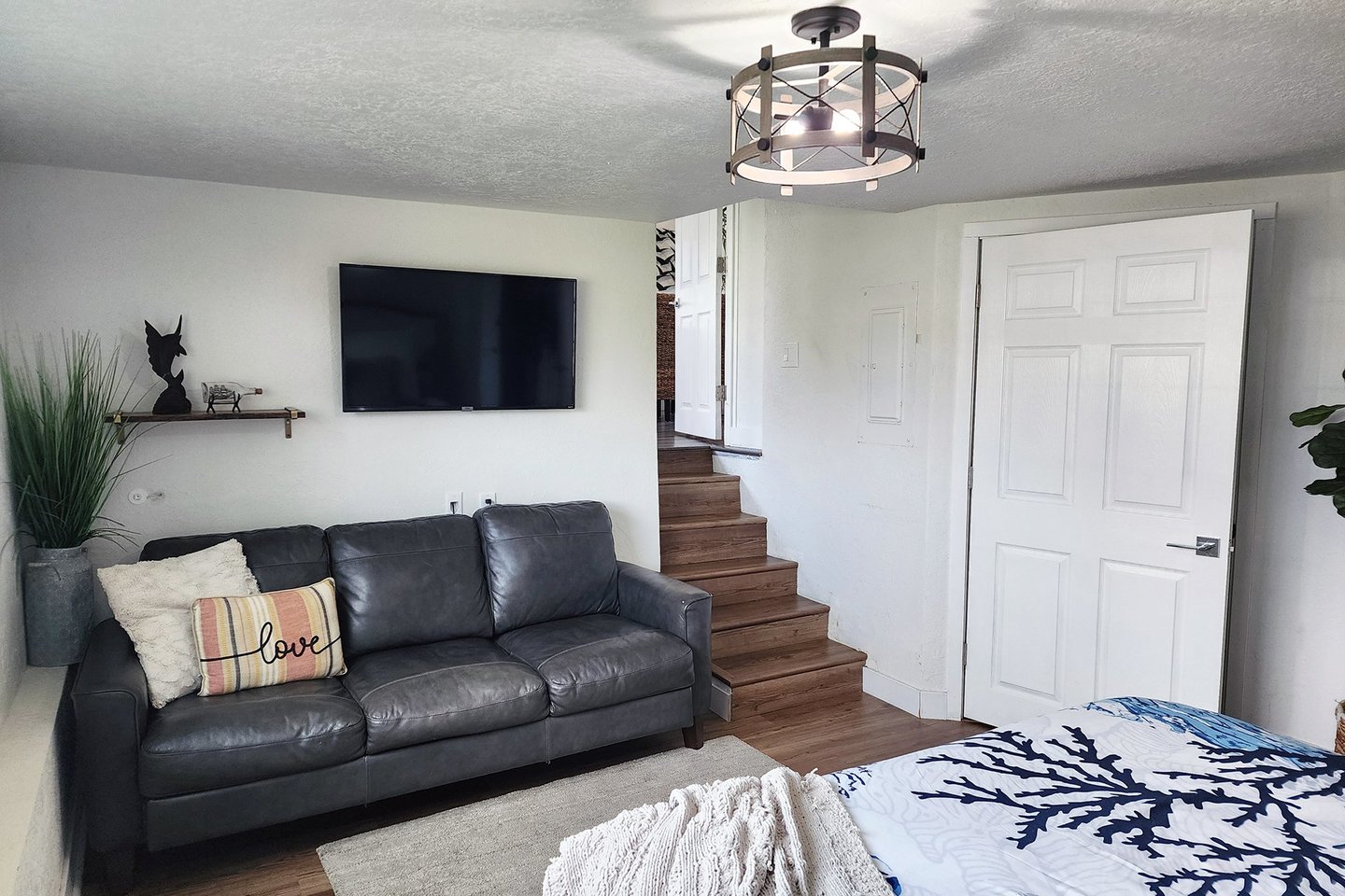 The spacious primary bedroom has a sofa and television.