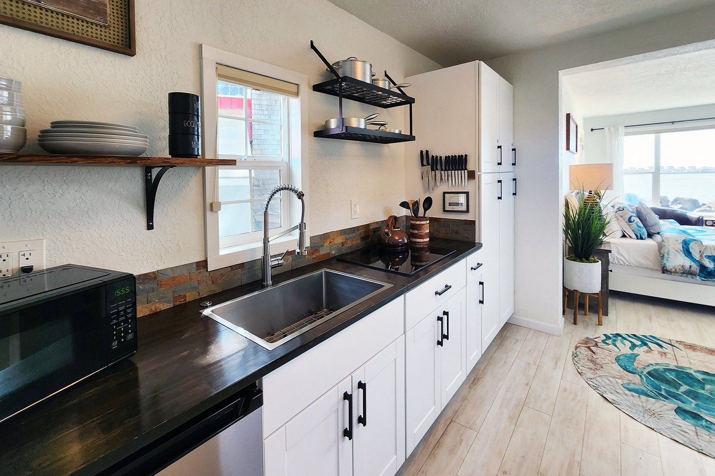 Studio: Lovely kitchen with farm sink, glass cook top and mini fridge.