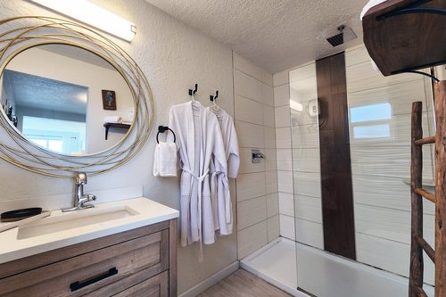 Studio: Spacious bath with walk in tiled shower.