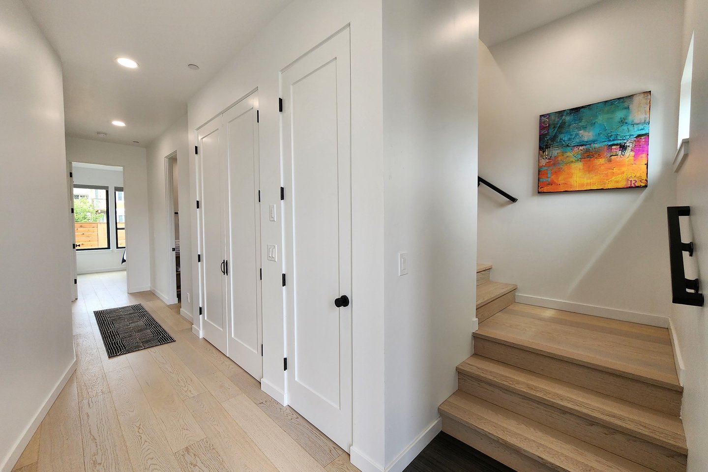 Main floor entrance hallway takes  you to a bedroom and den.