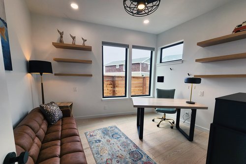 Den has futon twin futon and desk for a work-ation.