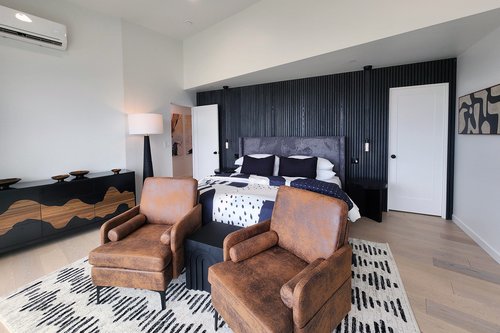 Primary suite with king bed and relaxing seating area.
