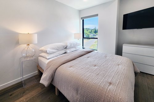 Third bedroom upstairs has a comfy queen bed and TV.