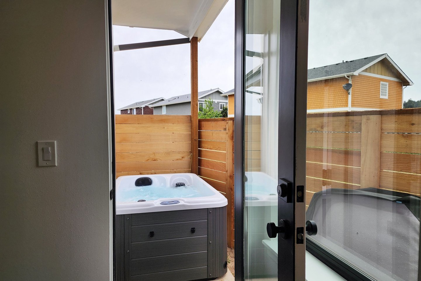 Two person hot tub found through the entry level bedroom,