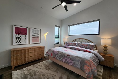 Primary bedroom with king bed and views of the Alsea Bay and Bridge.