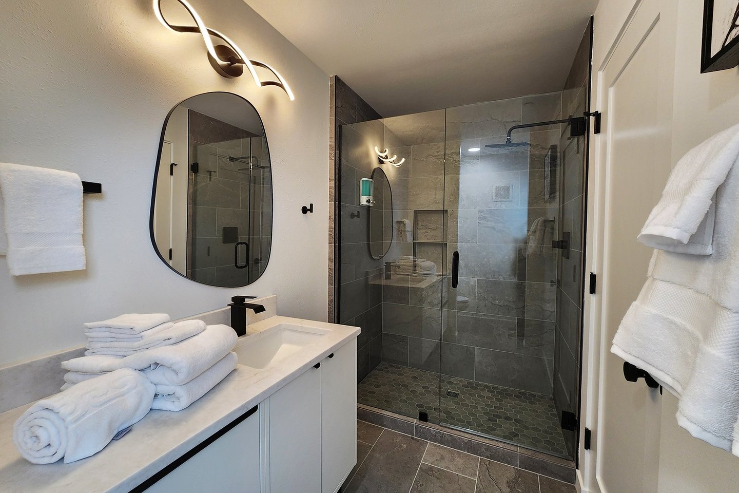 Primary ensuite bath with tiled walk in shower.