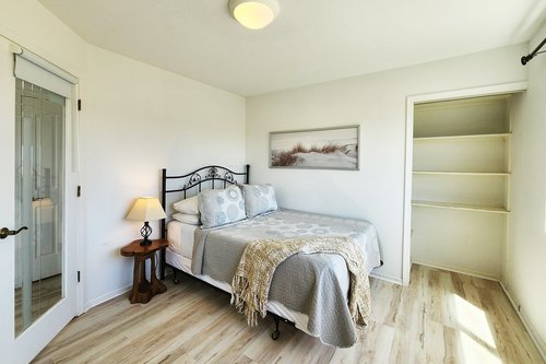 Comfy queen bed in spacious bedroom.