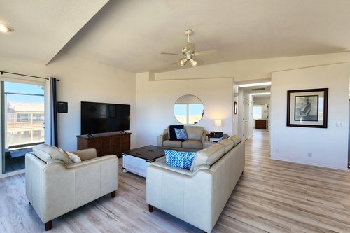 Spacious living room with large TV.