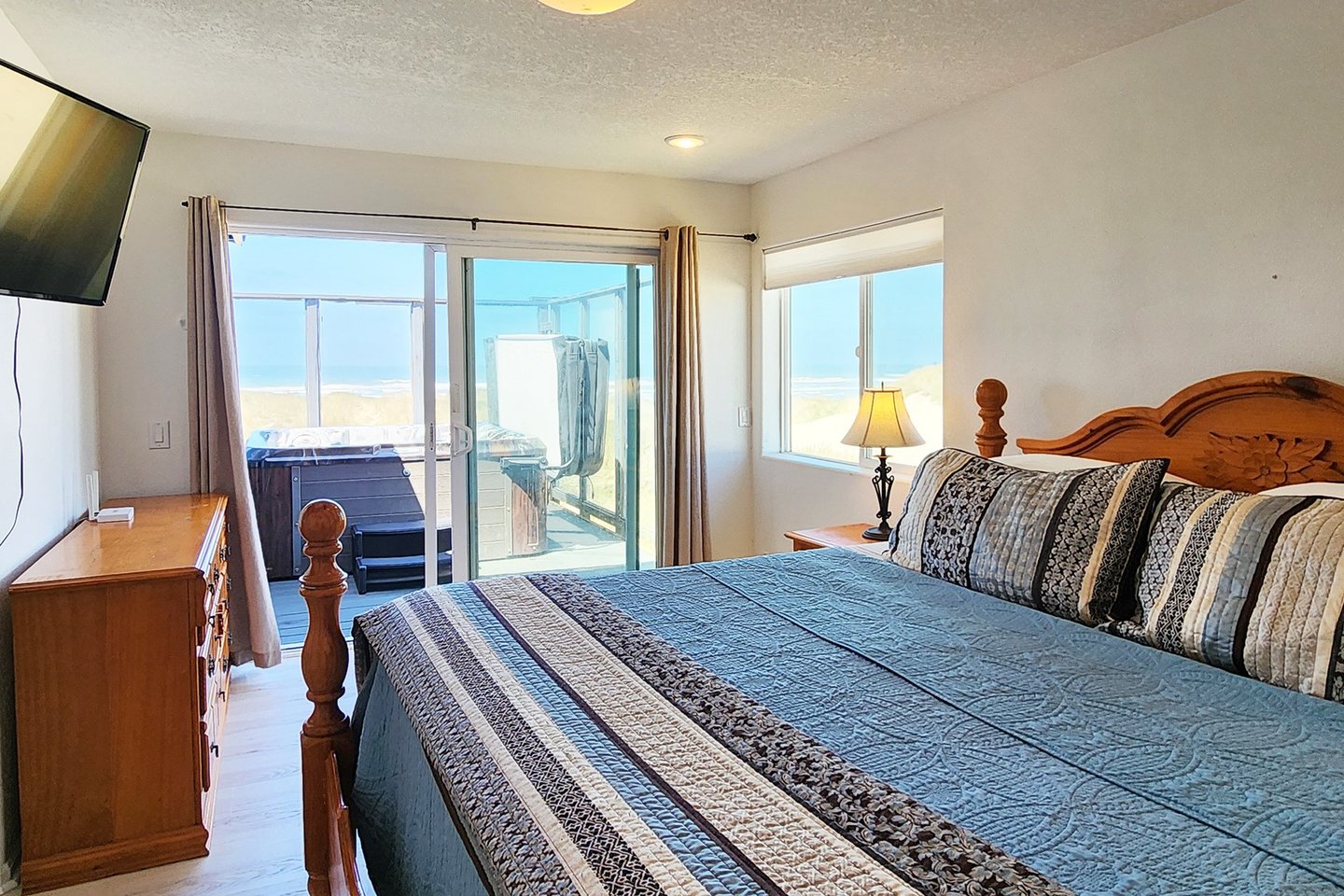 The primary suite with king bed and access to the deck w/hot tub.
