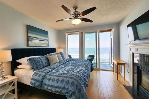 Primary suite has a king bed, an ocean front patio, fireplace and onsuite bath.