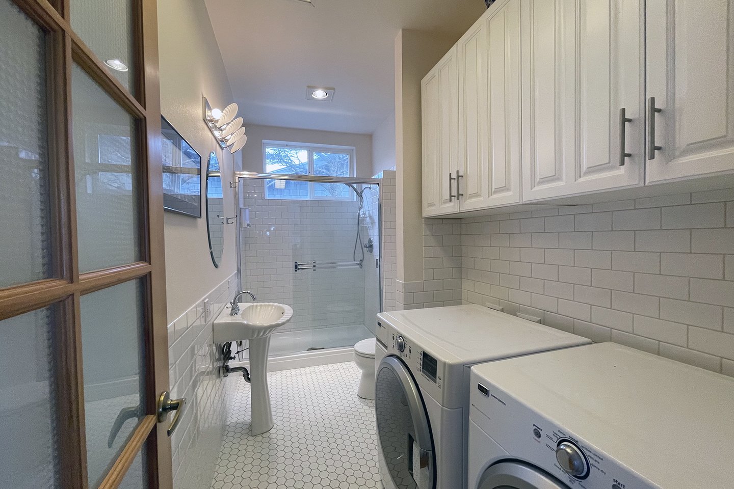 The hallway bath has a washer/dryer for added convenience.