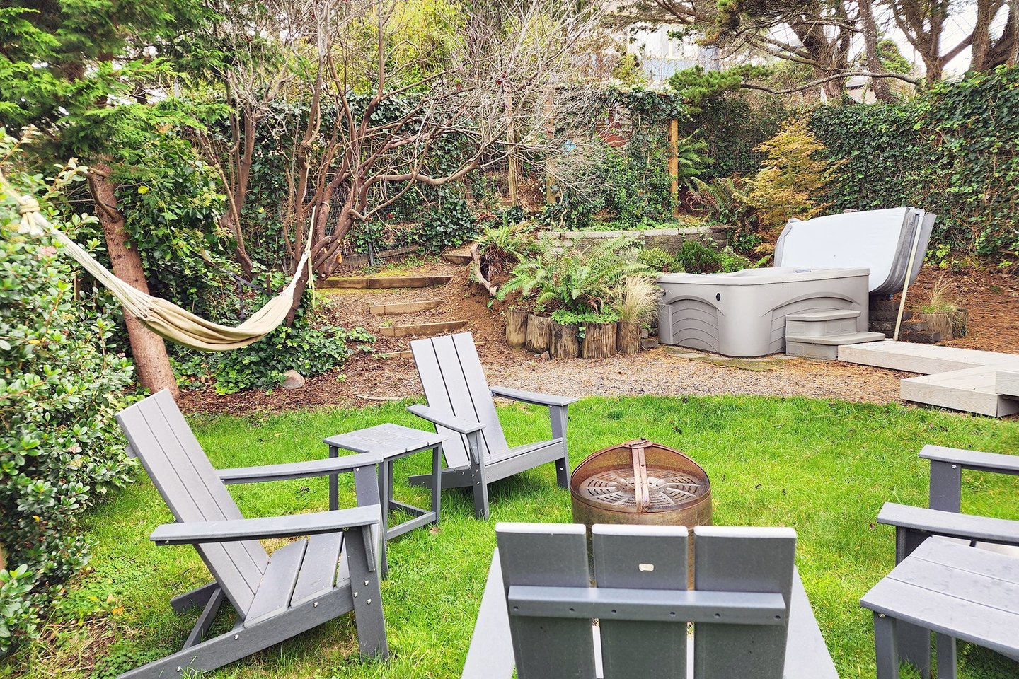 Relax and enjoy the hot tub, firepit and hammock!